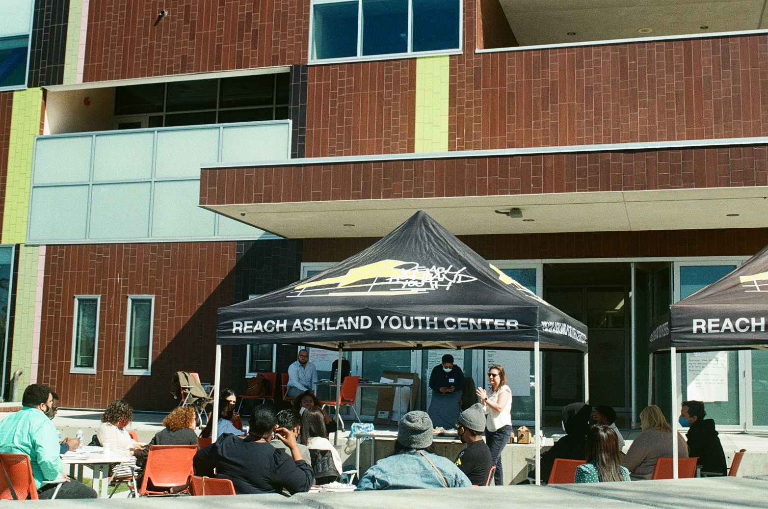 Wide shot of whole patio and youths participating in a discussion
